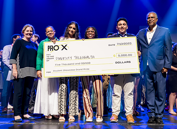 students hold large check as prize