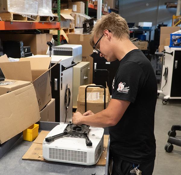 Trenton works on audio visual equipment