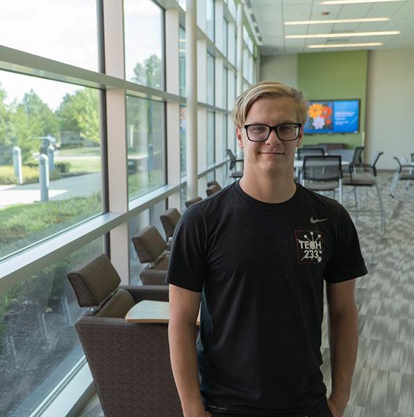 Trenton stands in atrium