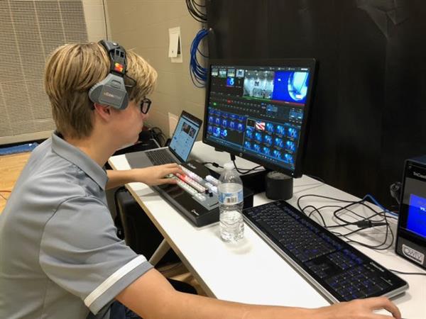 Trenton at the control board in high school