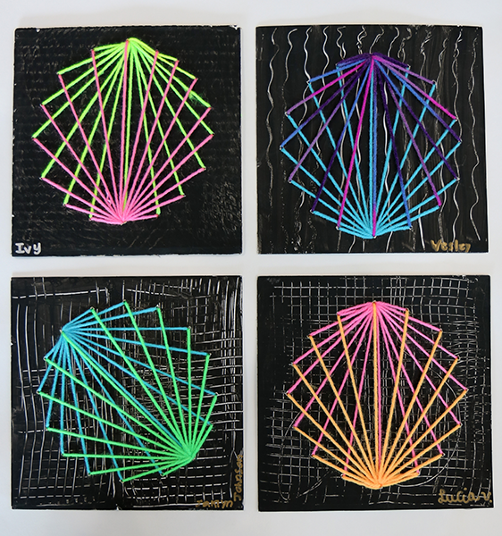 four pieces of string art on painted cardboard