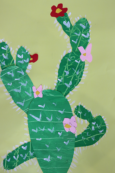 cactus made with layers of cut paper and white paint for needles