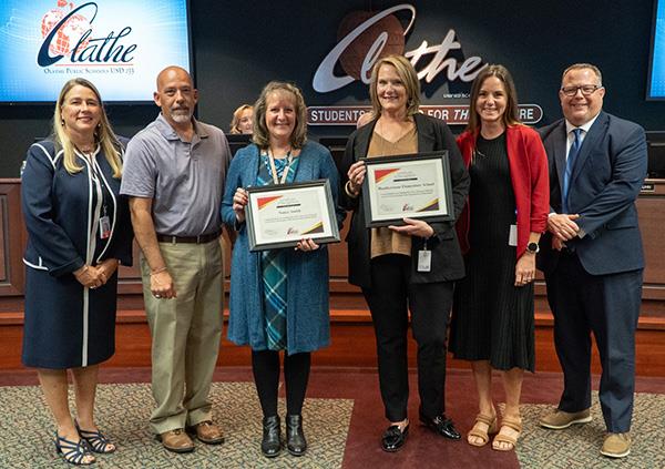 women presented with certificates at board meeting
