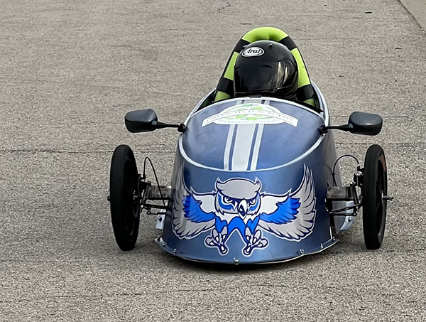 small, electric car racing on street track