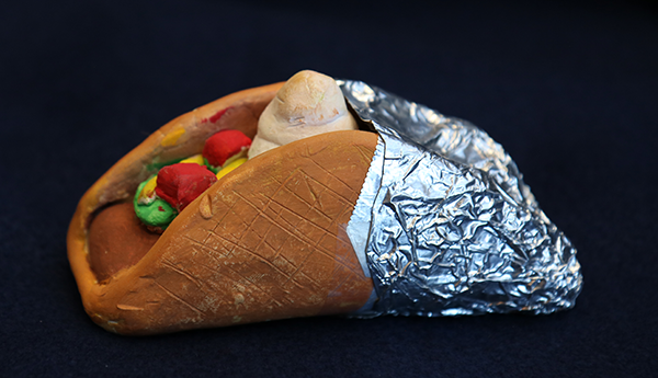 clay taco wrapped partly in aluminum foil