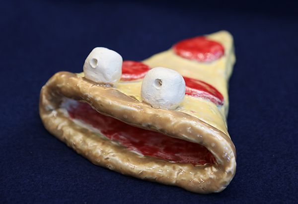 clay slice of pizza with monster eyes