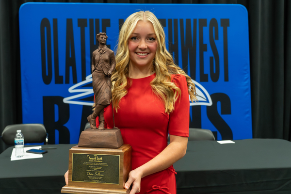 Claire holds her award trophy