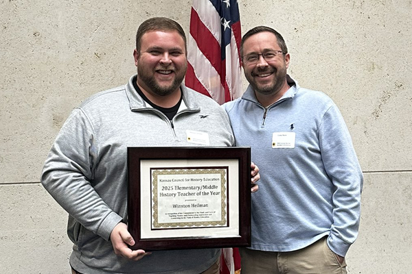 Winston receives his award certificate