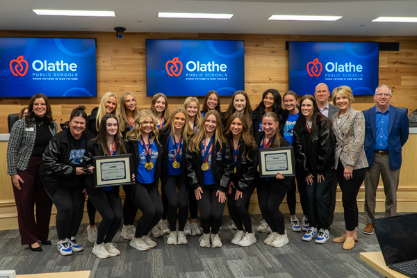 high school dancers honored at a board meeting