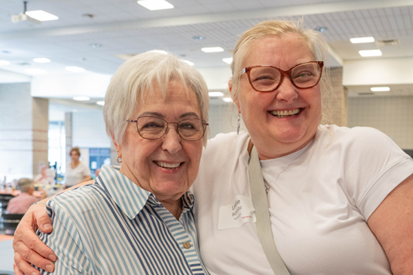 two women hug at celebration