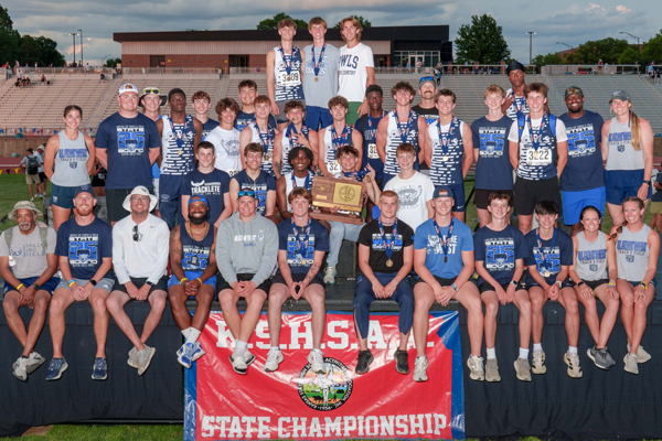 track team holding trophy for group photo